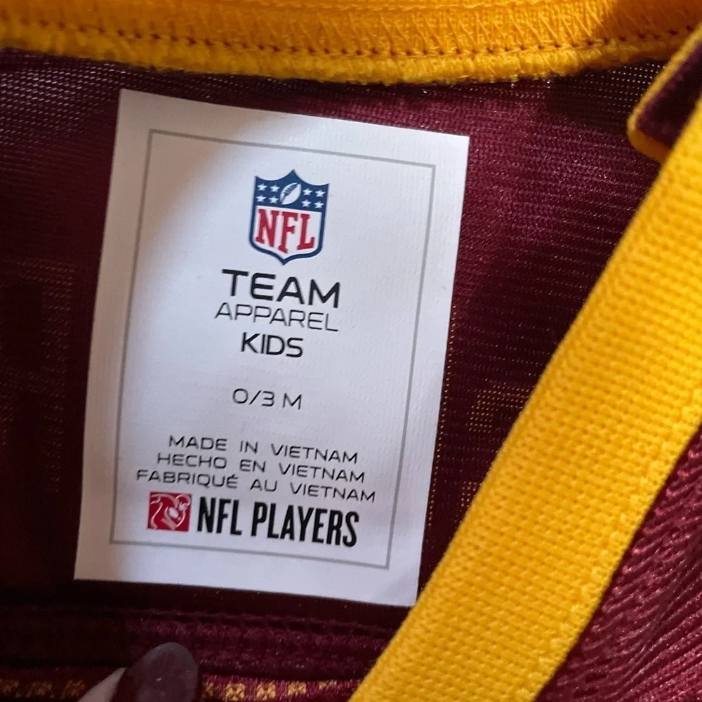 NFL Team Apparel Kids Maroon and Yellow Onesie